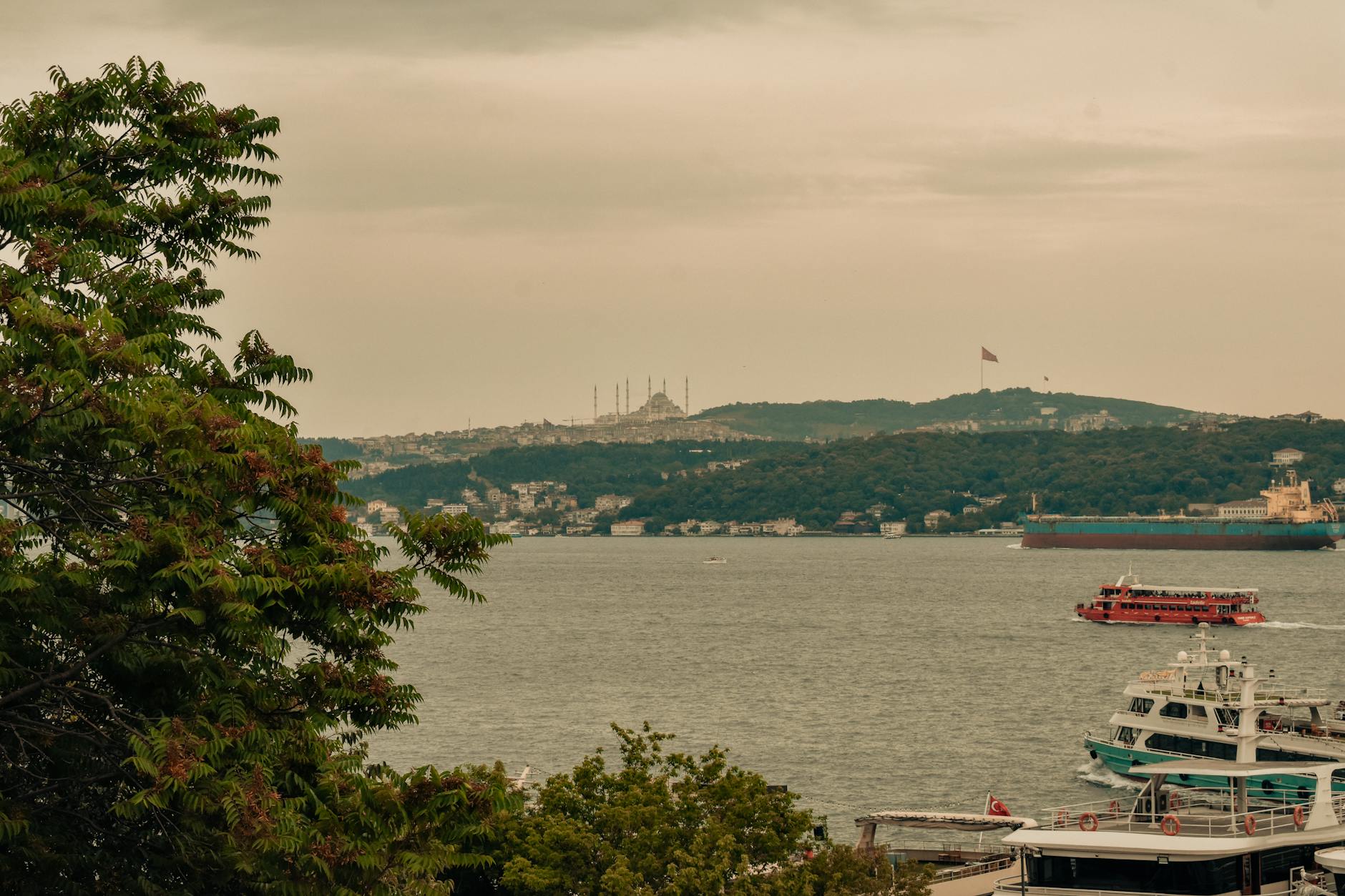 Zachmurzony Bosfor w Stambule z łodziami i meczetem w tle
